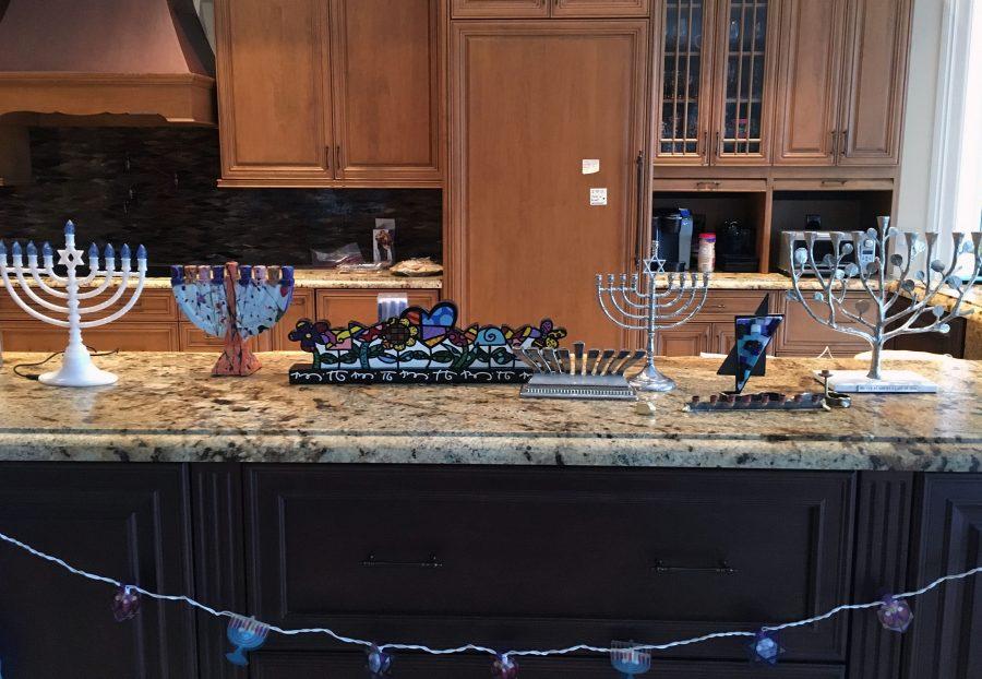 Freshman Lindsey Fine displays menorahs in preparation for Hanukkah.