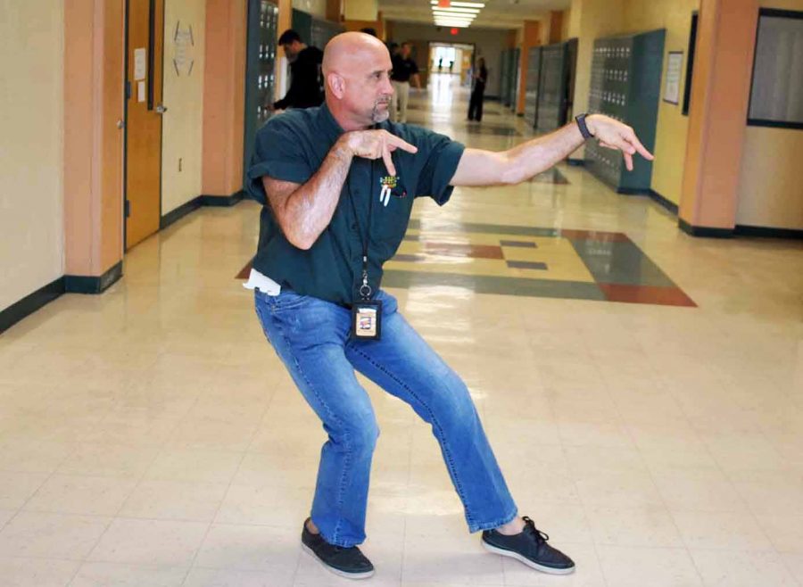 Mr. Jay Matousek demonstrates a Kung fu move in the hallway near the 7000 wing.