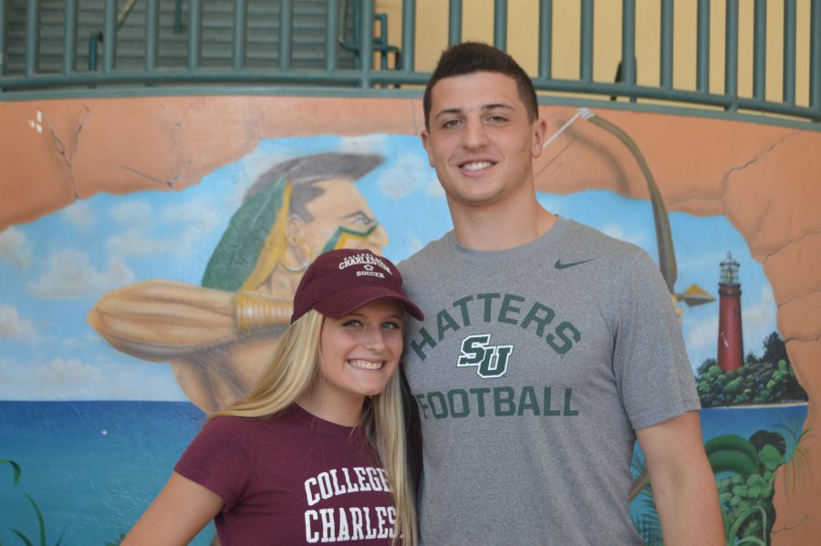 Seniors Haley Mannetta and Alex Piccirilli showing school spirit after signing their commitment letters in the Jupiter High atrium on National Signing Day.