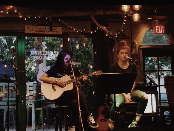 Sophomores Jillian Duke and Micelle Lopez playing at Double Roads Tavern. Photo by Walter Lopez