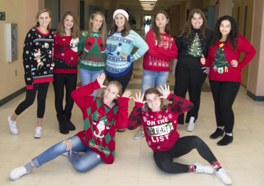 Jupiter War Cry staff shows off their festive holiday sweaters. 