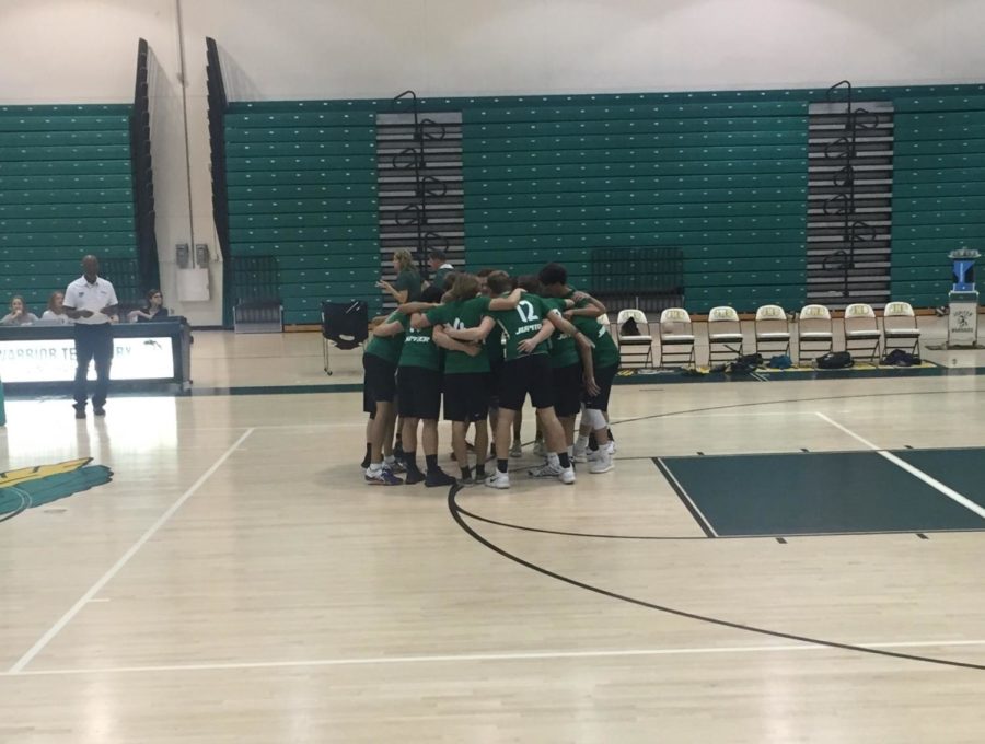 Boys volleyball huddle and warm up before a home game. 