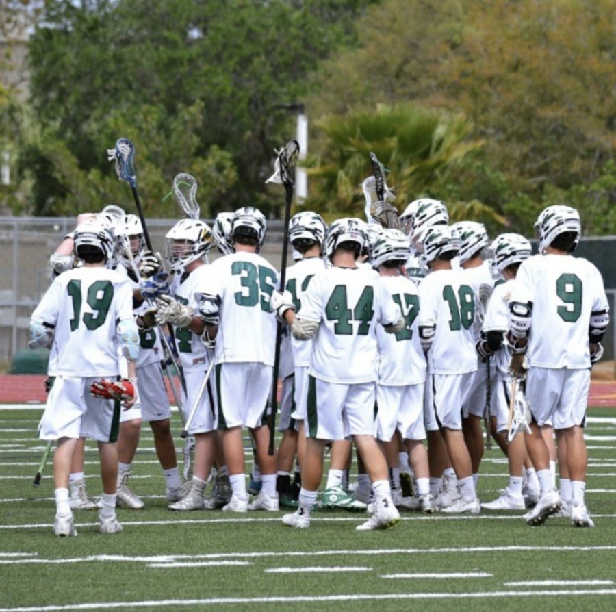 Boys lacrosse celebrate after a home game win.
