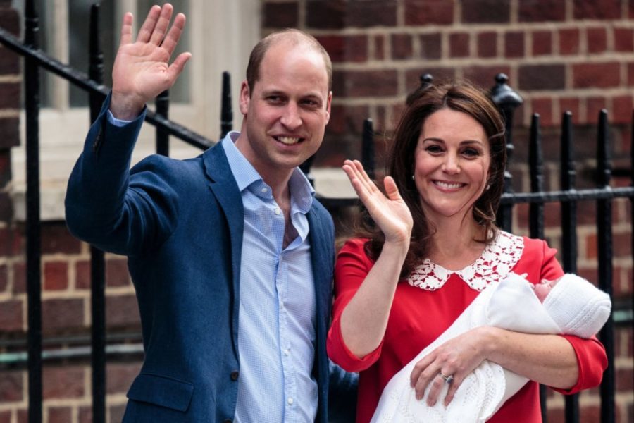 The Duke and Duchess of Cambridge hold their new-born child while waving to the members of the commonwealth.