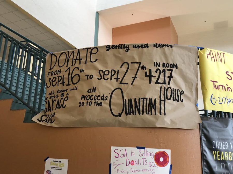Banner promoting the clothing drive and garage sale made by SGA hung in the Atrium