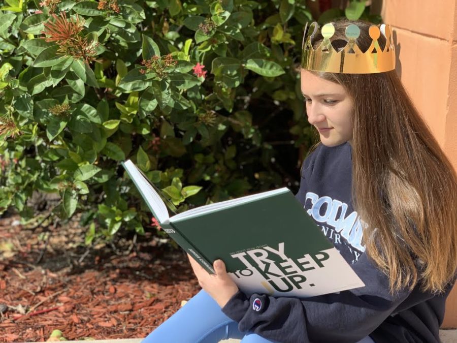 Yearbook staffer, junior Megan Palmieri looks through the award-winning yearbook Try to Keep Up while wearing a Columbia University sweatshirt she bought at CSPA last spring. She and the staff got paper gold crowns in celebration of their award. 