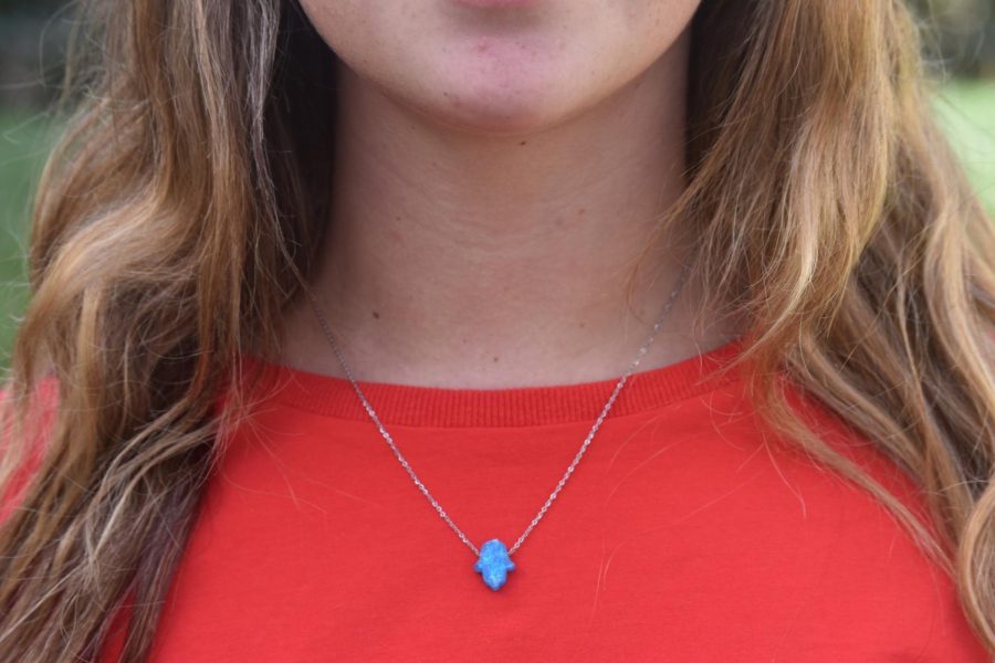 Senior Maya Milstein wears a blue hamsa necklace she got while in Israel to show she is proud to be Jewish