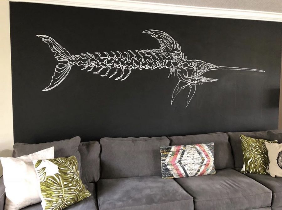 The mural senior Luke Shaw painted in a family friends living room that started his company.