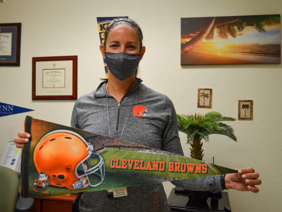 Assistant Principal Kelly Foss proudly displays her Cleveland Browns pennant, shirt and watch band on Jan. 11 after the Browns defeated the Steelers on Jan. 10.
