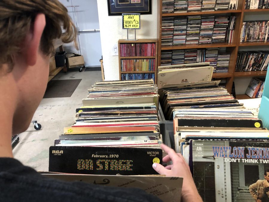 Teenager looks through vintage vinyl records