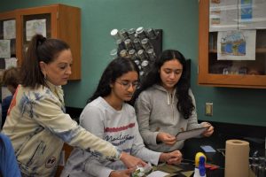Patricia Icart assists students with their lab project for class.