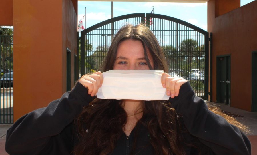 Payton Gottlieb holds a menstruation pad in front of her mouth to symbolize the silence of discussion over human growth and development topics.