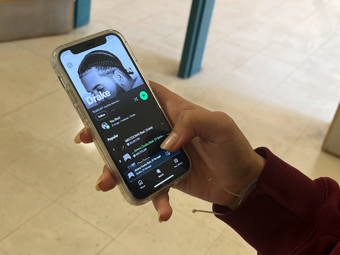 Student looking at Drakes Spotify profile. 