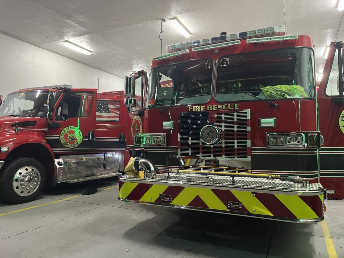 Two firetrucks parked in the garage of Fire Station 16.