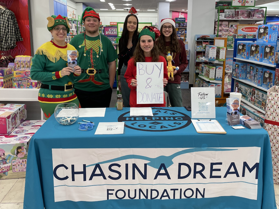 Interact Club members and sponsor gather toys from Macys for Chasin A Dream Foundations Annual Toy Drive.