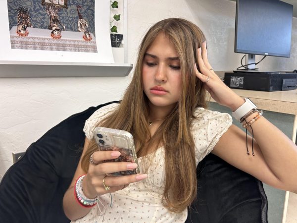 Scarlett Bolt looking at her phone