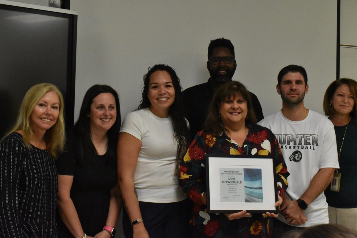 DePasquale being awarded the North Region Teacher of the Year Award surrounded by faculty