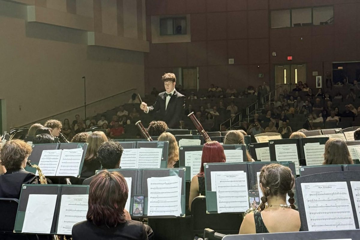 Student Conductor Connor Murphy Conducting a Piece in the Wind Symphony's Program